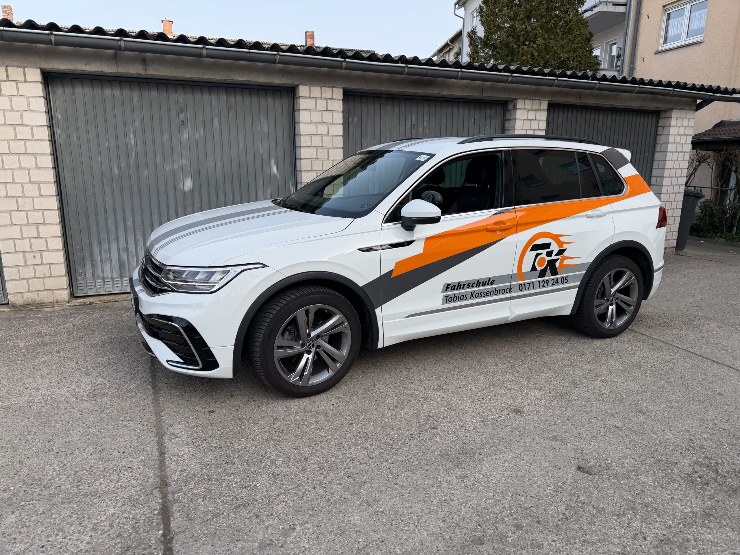 Car mechanic with wrench shows thumb up